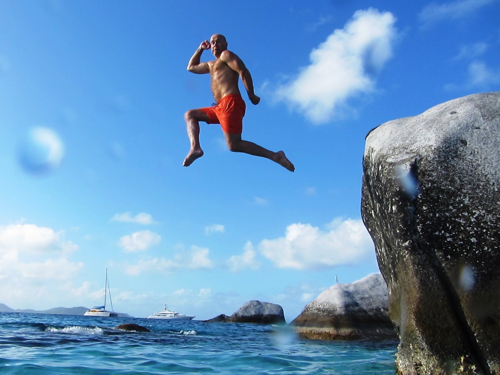 Photo of a guest jumping off a rock